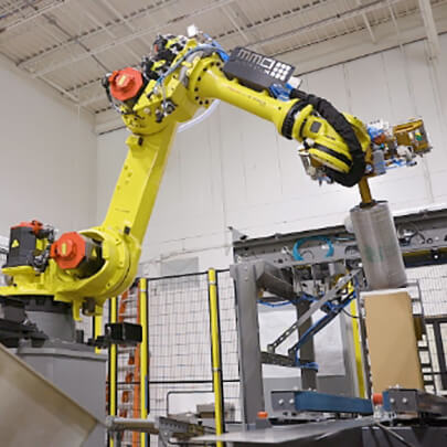 Robotic Palletizer packing a roll into a box