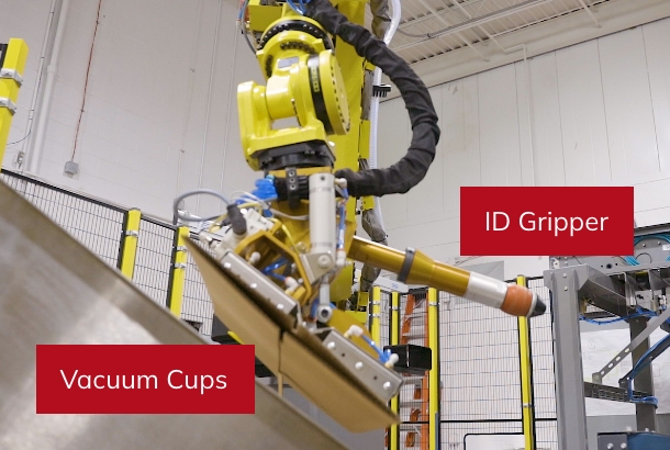 Roll handling robotic palletizer with vacuum cups and an ID gripper