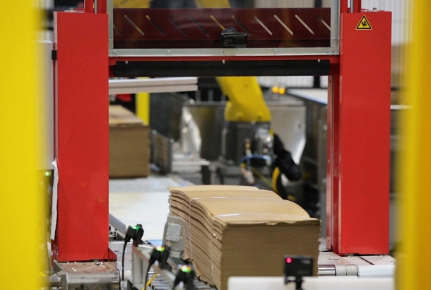 Bundles passing through safety sensors after being placed on a line by a robotic palletizer